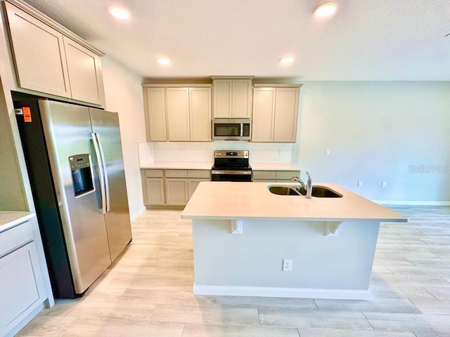 2834 Narcoossee Commons Way, Saint Cloud, FL 34771 - kitchen featuring stainless steel appliances, a sink, light wood-style floors, baseboards, and recessed lighting