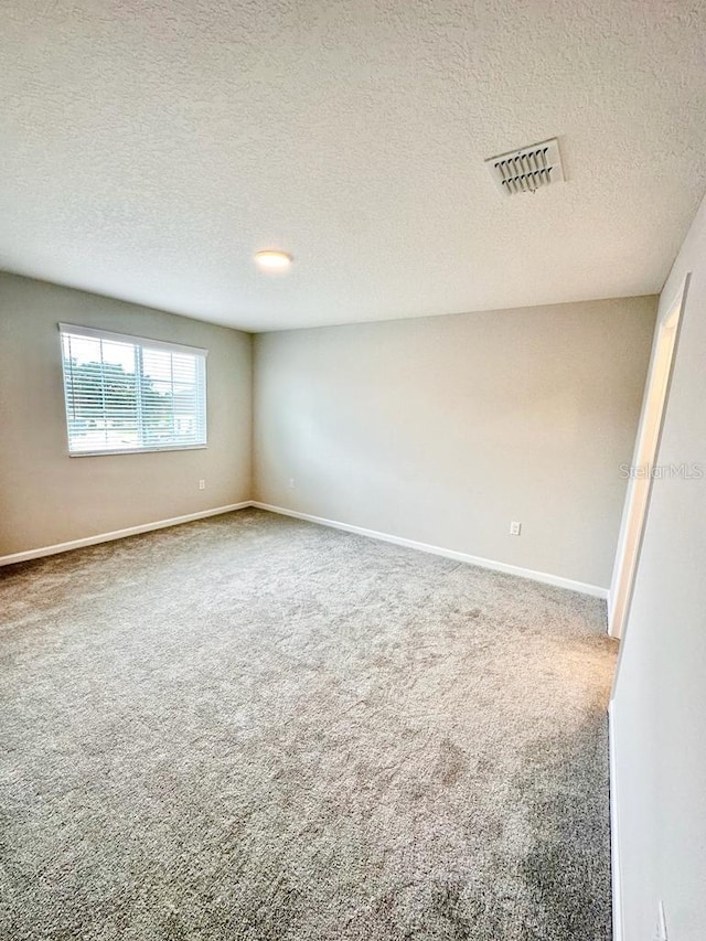 2834 Narcoossee Commons Way, Saint Cloud, FL 34771 - empty room with carpet floors, a textured ceiling, and baseboards