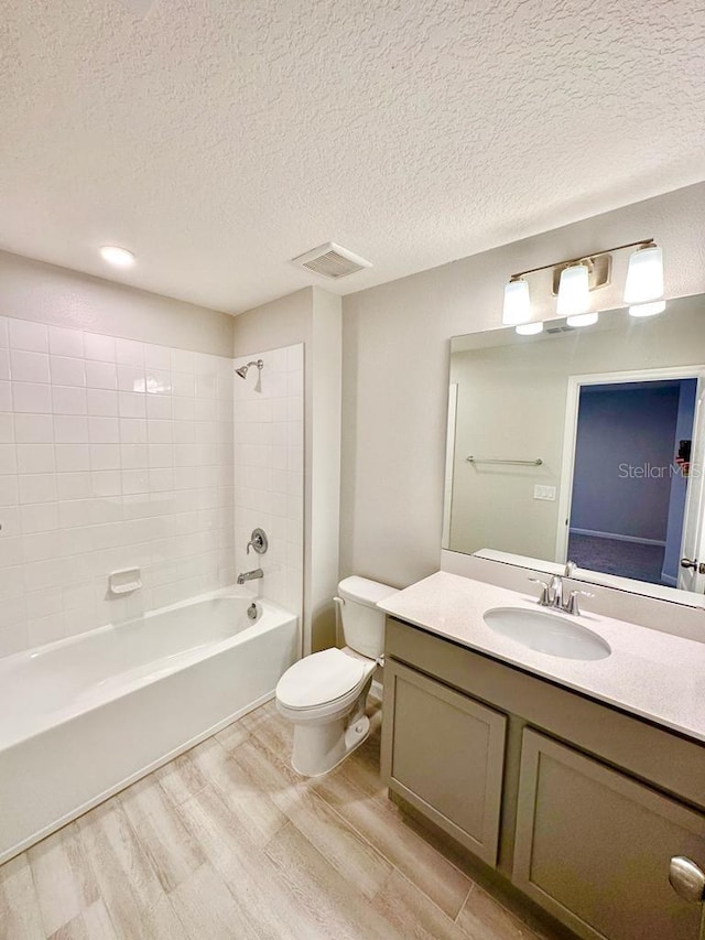 2834 Narcoossee Commons Way, Saint Cloud, FL 34771 - bathroom featuring wood finished floors, toilet, vanity,  shower combination, and a textured ceiling