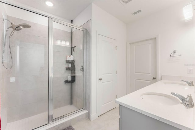 bathroom featuring a sink, visible vents, and a stall shower