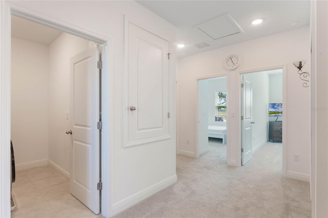 hallway with recessed lighting, baseboards, light colored carpet, and visible vents