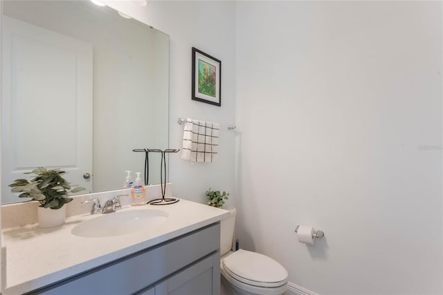 bathroom with toilet and vanity