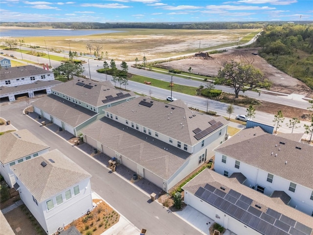 bird's eye view with a water view and a residential view