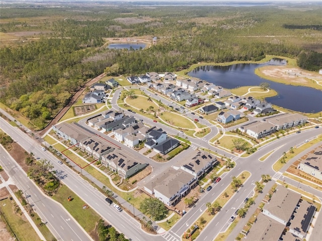 aerial view with a residential view, a water view, and a forest view