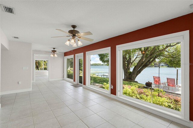 7706 Waunatta Ct, Winter Park, FL 32792 - unfurnished sunroom with a wealth of natural light, visible vents, and a water view