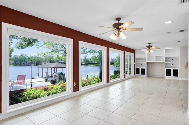 7706 Waunatta Ct, Winter Park, FL 32792 - unfurnished living room featuring light tile patterned floors, a water view, ceiling fan, and visible vents