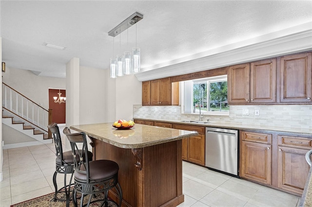 7706 Waunatta Ct, Winter Park, FL 32792 - kitchen with a kitchen breakfast bar, a center island, a sink, stainless steel dishwasher, and a notable chandelier