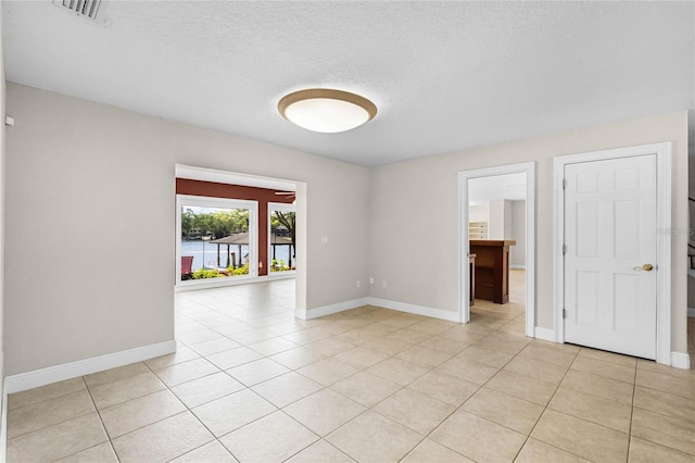 7706 Waunatta Ct, Winter Park, FL 32792 - unfurnished room featuring light tile patterned floors, a textured ceiling, baseboards, and visible vents