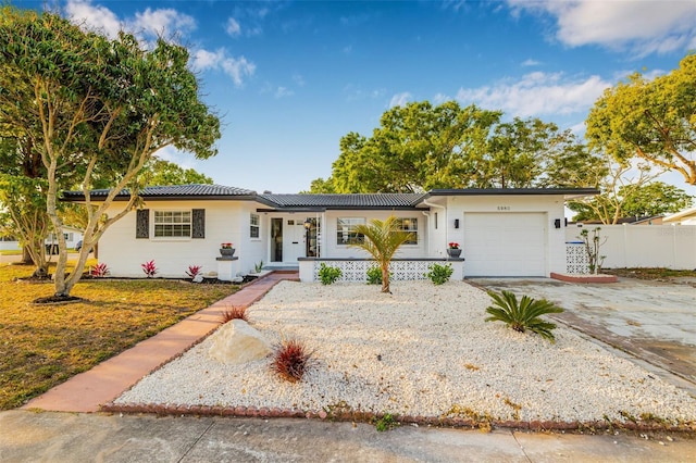 5980 32nd Ave N, Saint Petersburg, FL 33710 - ranch-style home featuring an attached garage, concrete driveway, and a porch