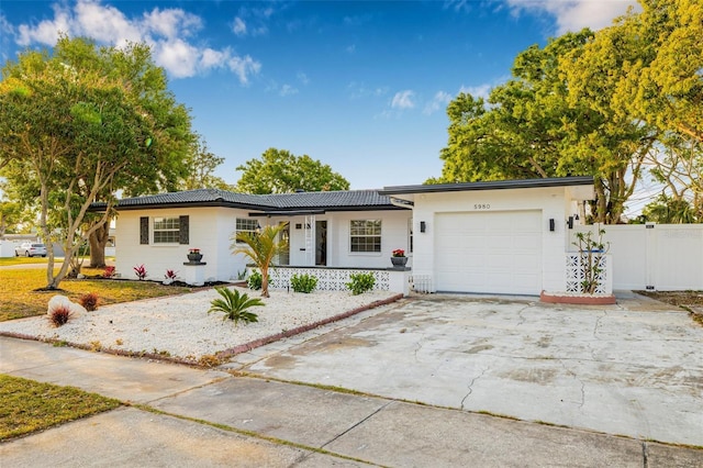 5980 32nd Ave N, Saint Petersburg, FL 33710 - single story home featuring a garage, covered porch, and driveway