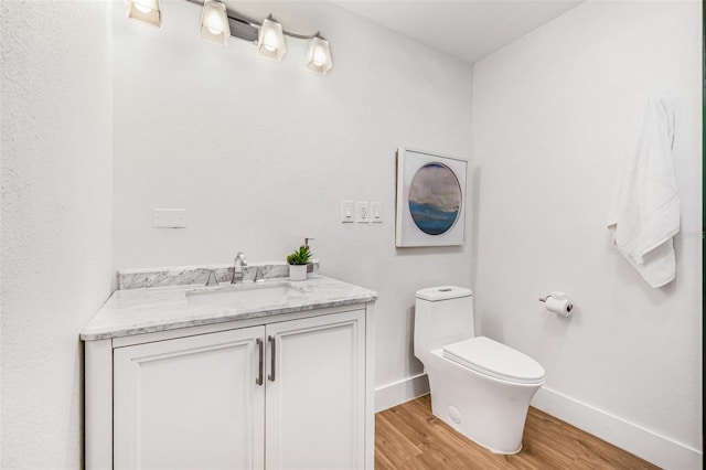 5980 32nd Ave N, Saint Petersburg, FL 33710 - bathroom featuring wood finished floors, baseboards, toilet, and vanity