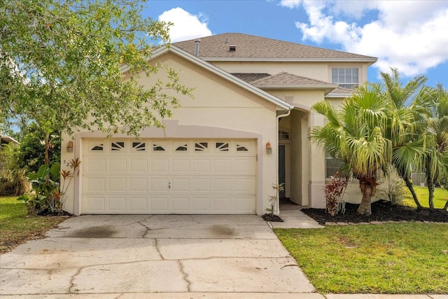 529 Tuten Trl, Orlando, FL 32828 - traditional-style house featuring a shingled roof, a garage, driveway, and stucco siding