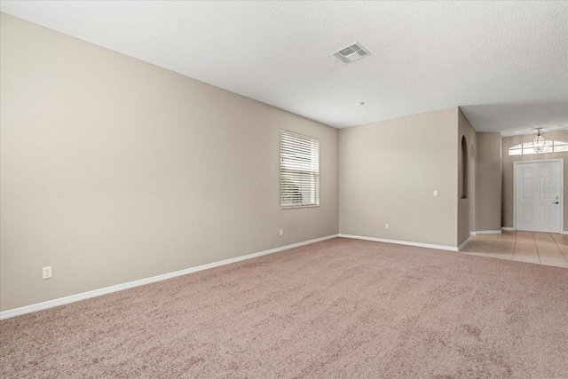 529 Tuten Trl, Orlando, FL 32828 - spare room featuring baseboards, visible vents, light colored carpet, and a textured ceiling