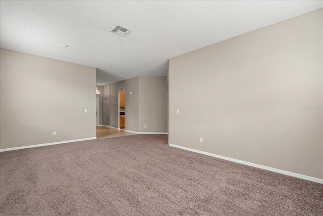 529 Tuten Trl, Orlando, FL 32828 - empty room with carpet flooring, visible vents, baseboards, and a textured ceiling