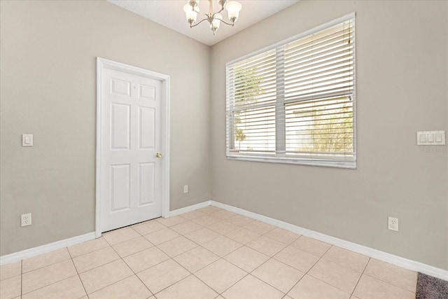 529 Tuten Trl, Orlando, FL 32828 - spare room featuring a chandelier, light tile patterned floors, and baseboards