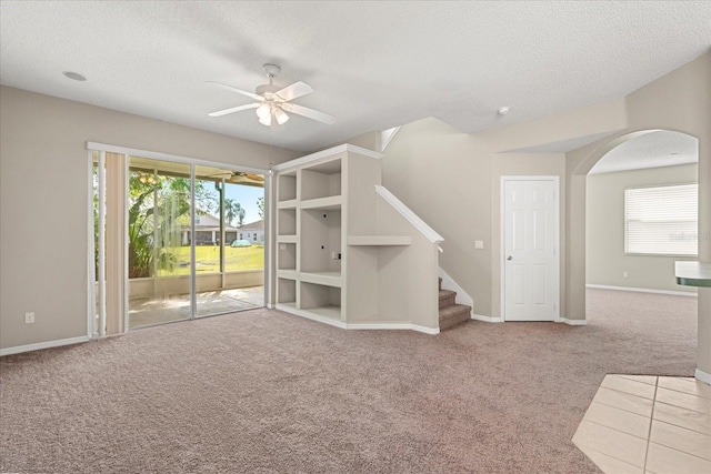 529 Tuten Trl, Orlando, FL 32828 - unfurnished living room featuring a textured ceiling, a healthy amount of sunlight, carpet flooring, and ceiling fan