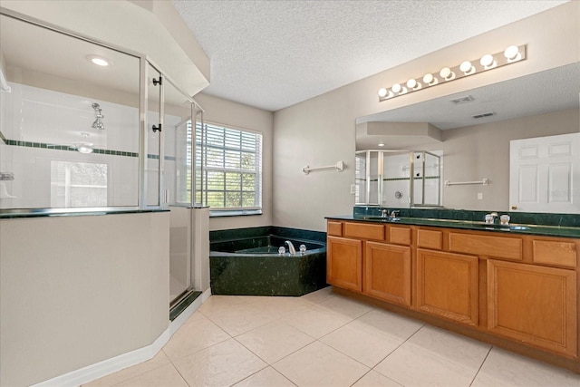 529 Tuten Trl, Orlando, FL 32828 - full bathroom featuring a bath, a textured ceiling, a sink, a stall shower, and double vanity