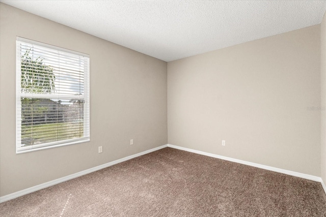 529 Tuten Trl, Orlando, FL 32828 - carpeted spare room with a textured ceiling and baseboards