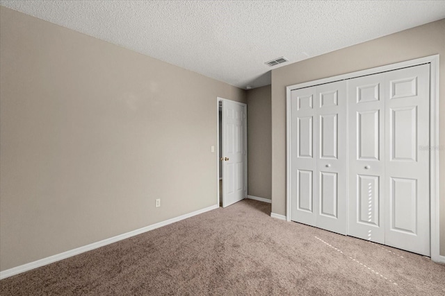529 Tuten Trl, Orlando, FL 32828 - unfurnished bedroom featuring carpet, a textured ceiling, a closet, visible vents, and baseboards