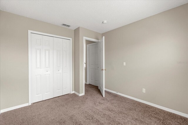 529 Tuten Trl, Orlando, FL 32828 - unfurnished bedroom featuring a closet, carpet flooring, visible vents, and baseboards