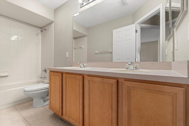 529 Tuten Trl, Orlando, FL 32828 - full bathroom featuring toilet, a textured ceiling, a sink, and tile patterned flooring
