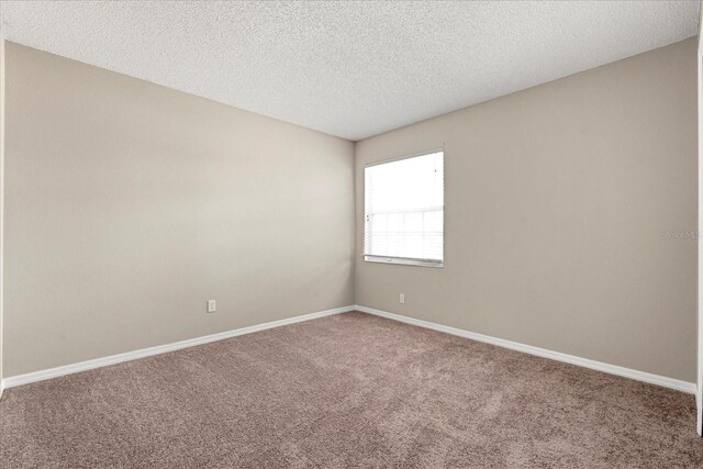529 Tuten Trl, Orlando, FL 32828 - carpeted spare room with a textured ceiling and baseboards