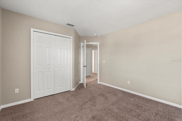 529 Tuten Trl, Orlando, FL 32828 - unfurnished bedroom with visible vents, baseboards, a closet, a textured ceiling, and carpet floors