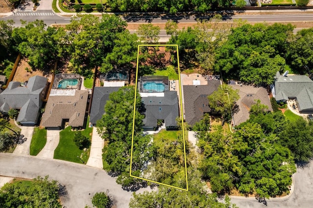 aerial view of residential area with a pool and property boundaries highlighted