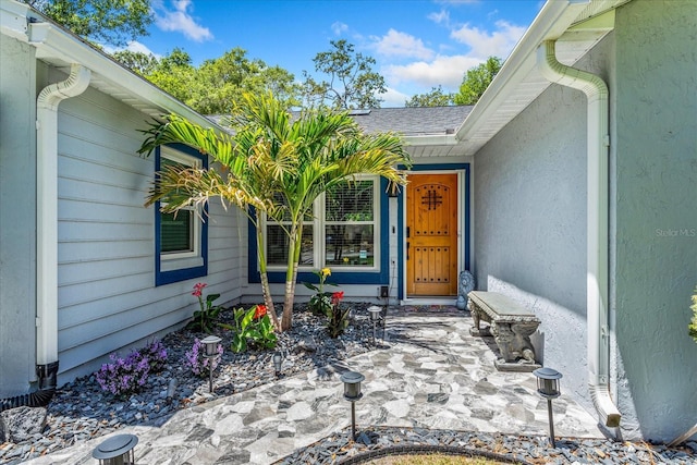 entrance to property featuring stucco siding