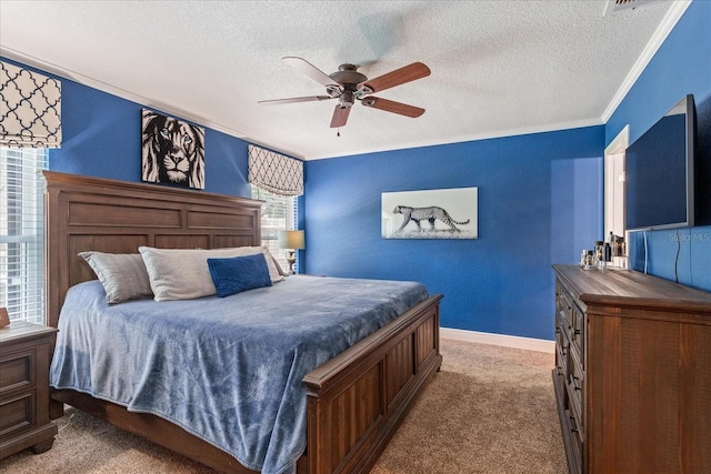 bedroom with a textured ceiling, carpet floors, crown molding, a ceiling fan, and baseboards