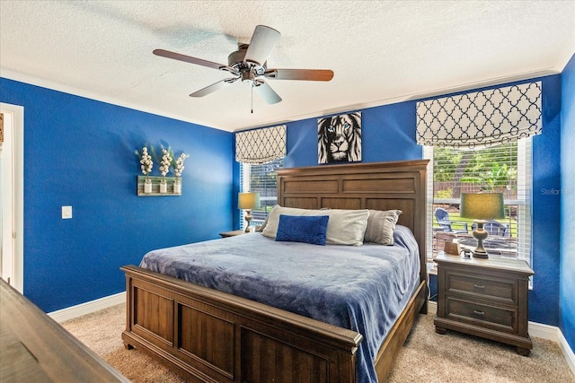 bedroom featuring light colored carpet, baseboards, a textured ceiling, crown molding, and a ceiling fan