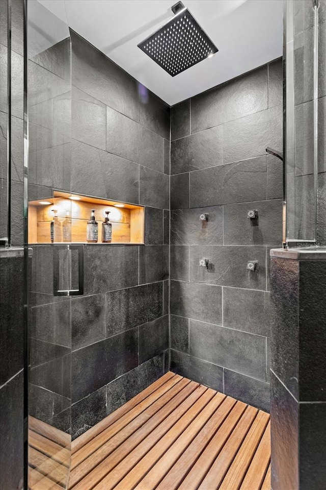 bathroom with a tile shower
