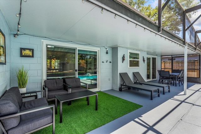 view of patio / terrace with an outdoor living space, outdoor dining space, and glass enclosure