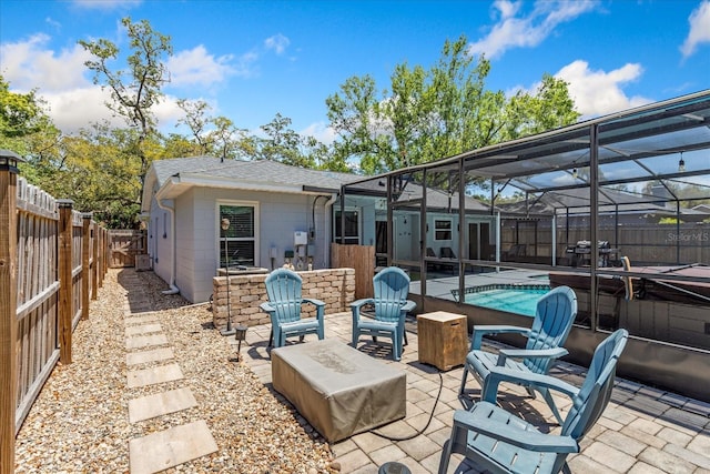 view of patio / terrace with a fenced backyard and a lanai