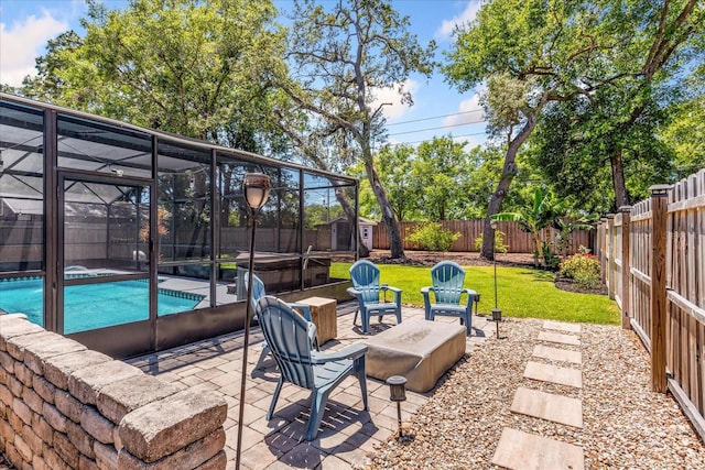 view of patio / terrace featuring a storage unit, glass enclosure, and an outbuilding