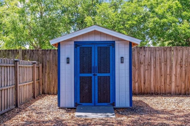 view of shed with a fenced backyard