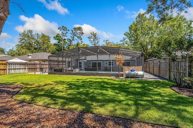 back of property with a swimming pool, a patio, and a lanai