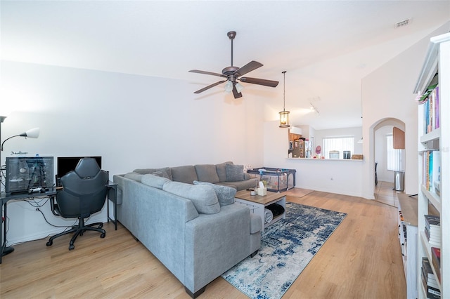 2637 Shelby Ruth Pl, Saint Cloud, FL 34769 - living room with arched walkways, ceiling fan, visible vents, and light wood-type flooring