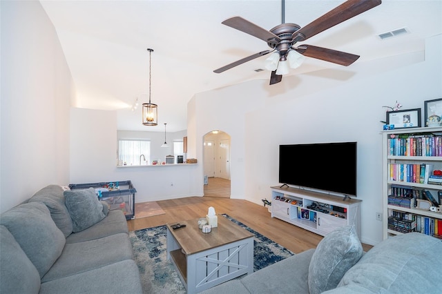 2637 Shelby Ruth Pl, Saint Cloud, FL 34769 - living room with vaulted ceiling, arched walkways, visible vents, a ceiling fan, and wood finished floors