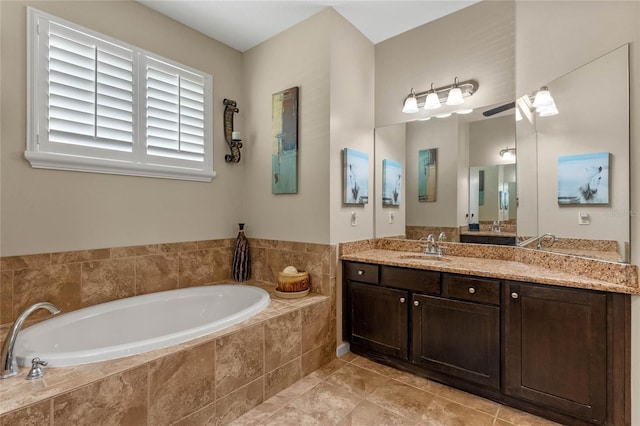 bathroom featuring tile patterned flooring, vanity, and a garden tub