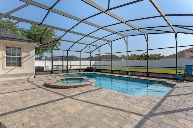 view of pool with a patio area, a fenced backyard, a pool with connected hot tub, and a lanai