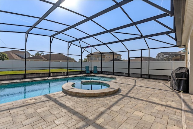 view of pool featuring grilling area, a patio area, a pool with connected hot tub, glass enclosure, and fence