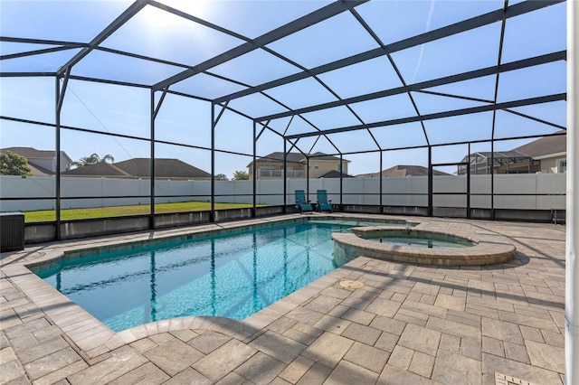 view of pool with a lanai, a patio, and fence