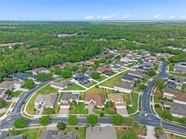 aerial view featuring a forest view and a residential view