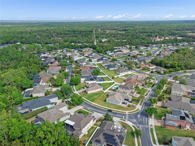birds eye view of property with a view of trees and a residential view