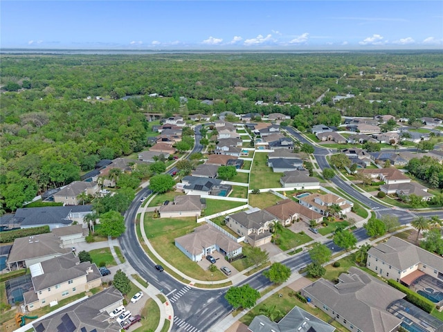 birds eye view of property featuring a residential view and a forest view