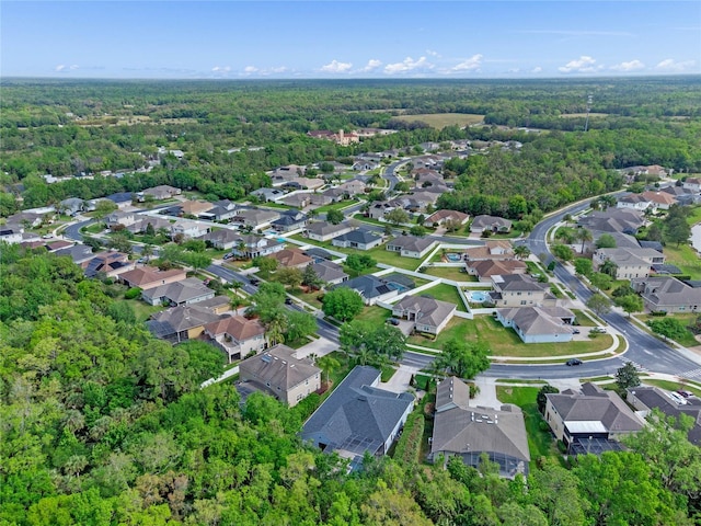 birds eye view of property featuring a view of trees and a residential view