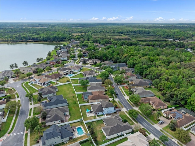 birds eye view of property featuring a forest view, a residential view, and a water view
