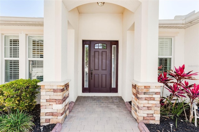 property entrance with stucco siding
