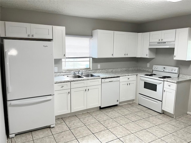 kitchen featuring light countertops, a sink, white cabinetry, under cabinet range hood, and white appliances